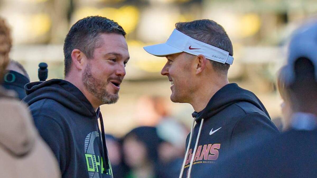  Oregon head coach Dan Lanning, left, and USC head coach Lincoln Riley shake hands before the game as the Oregon Ducks host the USC Trojans on Nov. 22, 2025, at Autzen Stadium in Eugene, Oregon. | Ben Lonergan/The Register-Guard / USA TODAY NETWORK via Imagn Images 