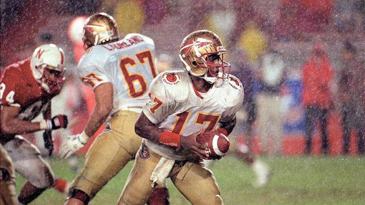  Jan. 1, 1993; Miami, FL, USA; Charlie Ward fakes a handoff in a rainstorm during last year's Orange Bowl game against Nebraska; Mandatory Credit: Phil Sears-USA TODAY NETWORK | USA TODAY Network via Reuters Connect 