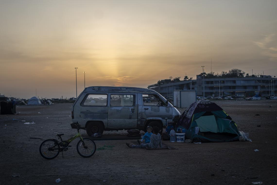 Young internally displaced people sit by a tent in Beirut, April 16, 2026. President Trump announced on Thursday that the leaders of Israel and Lebanon had agreed to begin a 10-day cease-fire at 5 p.m. Eastern time. (Diego Ibarra Sánchez/The New York Times)
