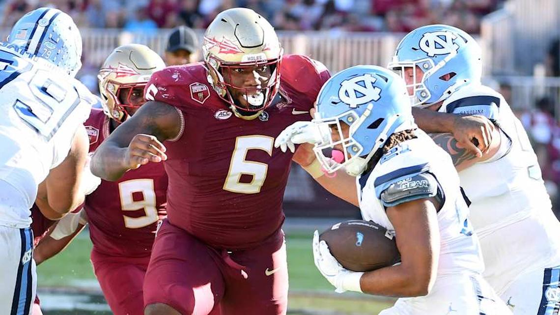  Nov 2, 2024; Tallahassee, Florida, USA; Florida State Seminoles defensive tackle Darrell Jackson Jr (6) pursues North Carolina Tarheels running back Davion Gause (21) in the second quarter at Doak S. Campbell Stadium. Mandatory Credit: Robert Myers-Imagn Images | Robert Myers-Imagn Images 