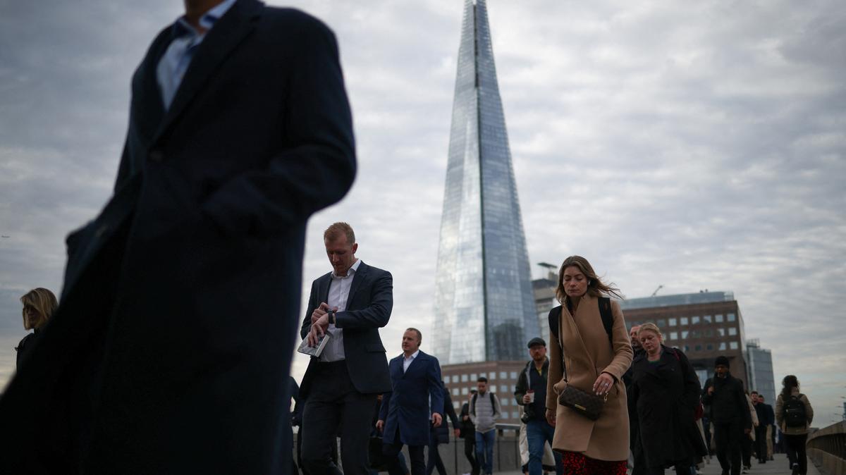 People walk over London Bridge towards the City of London financial district during rush hour in London, Britain, October 3, 2022. REUTERS/Henry Nicholls