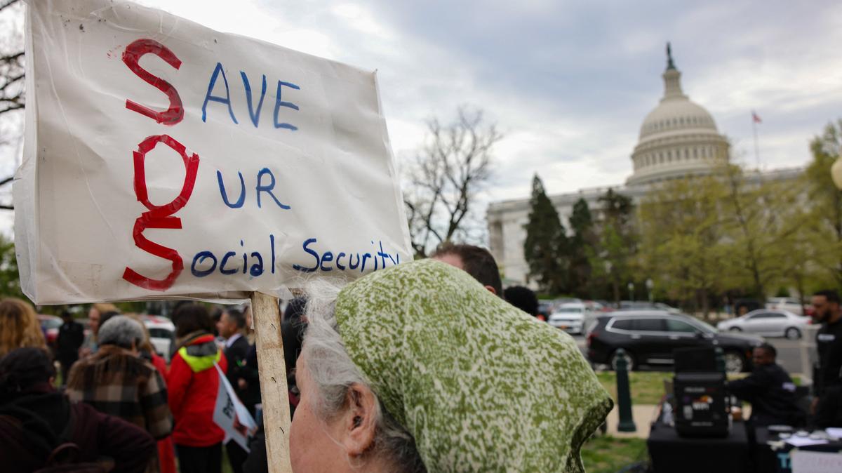 A person holds a sign reading "Save Our Social Security" during a press conference and rally in support of fair taxation near the U.S. Capitol in Washington, D.C., on April 10, 2025. (Bryan Dozier/Middle East Images/AFP/Getty Images/TNS)