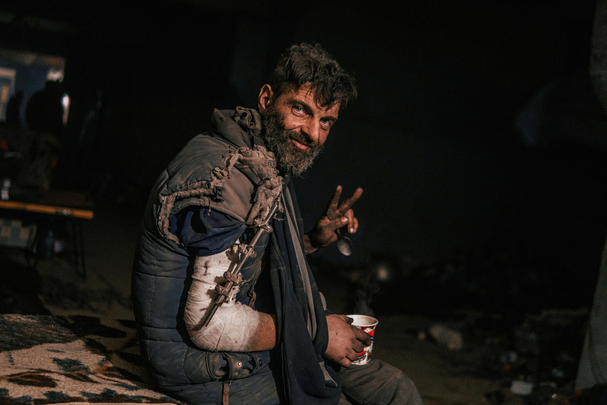 FILE PHOTO: An injured Ukrainian service member sits at a field hospital inside a bunker of the?Azovstal?Iron and Steel Works in Mariupol,, Ukraine, in this handout picture taken May 10, 2022. Dmytro Orest Kozatskyi/Press service of Azov Regiment/Handout via REUTERS
