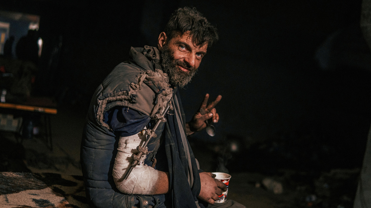 FILE PHOTO: An injured Ukrainian service member sits at a field hospital inside a bunker of the?Azovstal?Iron and Steel Works in Mariupol,, Ukraine, in this handout picture taken May 10, 2022. Dmytro Orest Kozatskyi/Press service of Azov Regiment/Handout via REUTERS