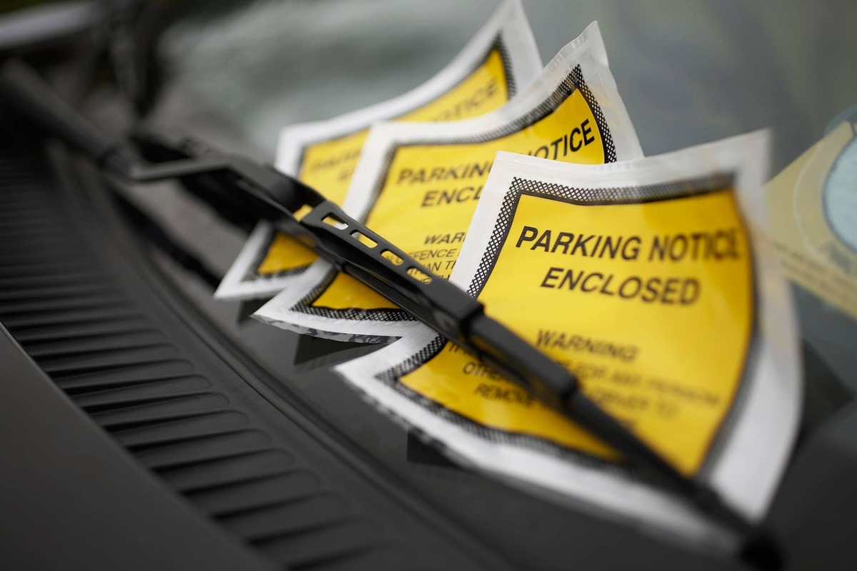  Parking tickets under the windshield wiper, close-up