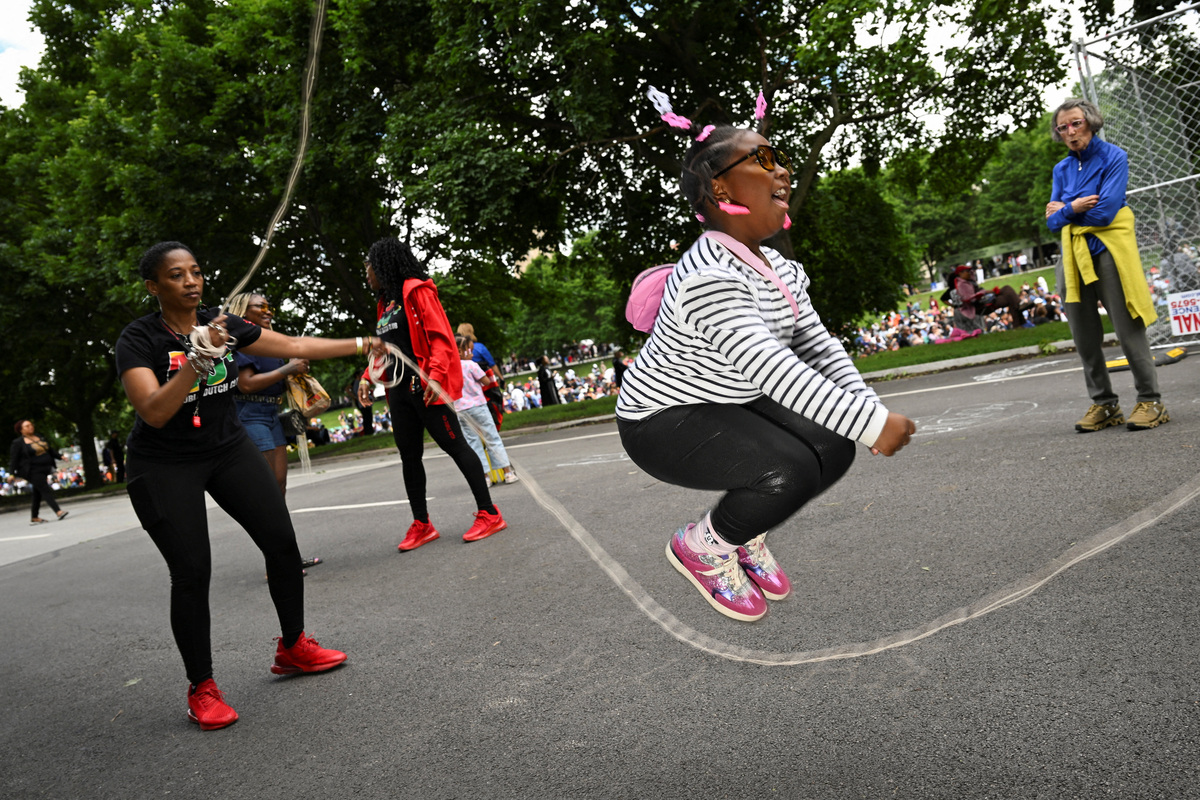 People play with a jump rope on the day of a watch party at the Midway Plaisance Park for the opening of the Obama Presidential Center in Chicago, Illinois, U.S., June 18, 2026. REUTERS/Joshua Lott