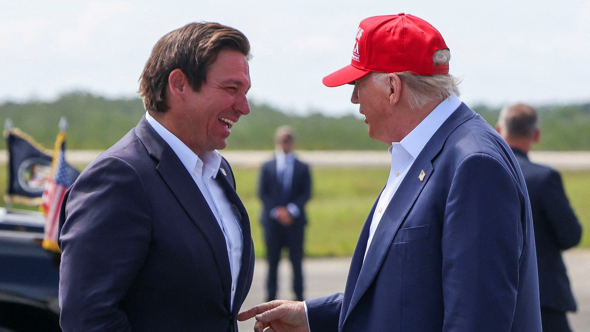 FILE PHOTO: U.S. President Donald Trump gestures as he speaks with Florida Governor Ron DeSantis at the Dade-Collier Training and Transition Airport on the day of the opening of a temporary migrant detention center informally known as "Alligator Alcatraz" in Ochopee, Florida, U.S., July 1, 2025. REUTERS/Evelyn Hockstein/File Photo