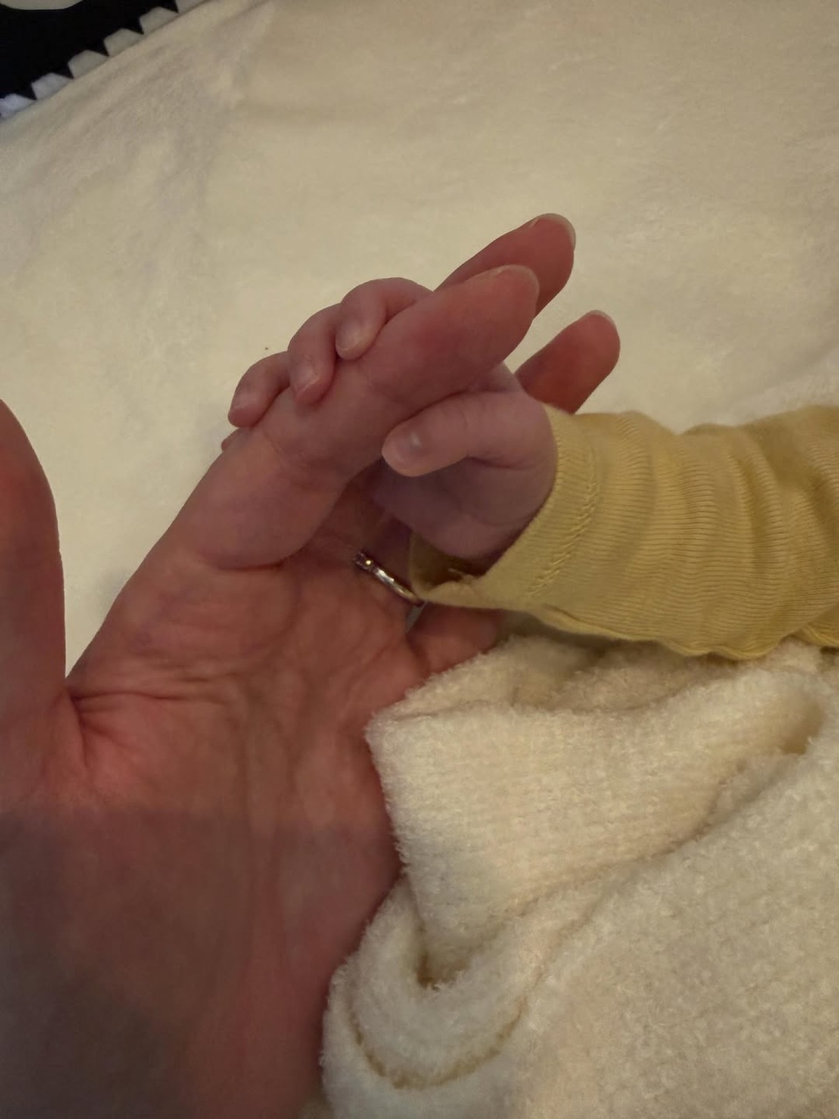 Hailee Steinfeld's daughter, Harper, holding her hand.