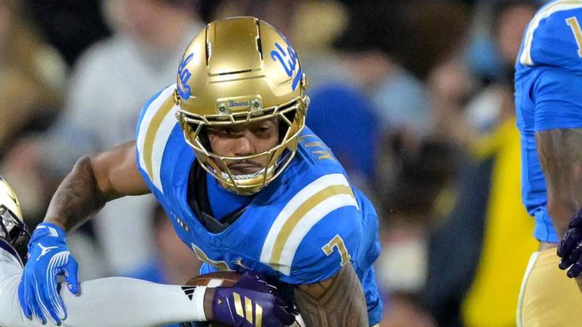  Nov 22, 2025; Pasadena, California, USA; Washington Huskies safety Rahshawn Clark (2) forces a fumble by UCLA Bruins wide receiver Mikey Matthews (7) during the first half the Rose Bowl. Mandatory Credit: Jayne Kamin-Oncea-Imagn Images | Jayne Kamin-Oncea-Imagn Images 