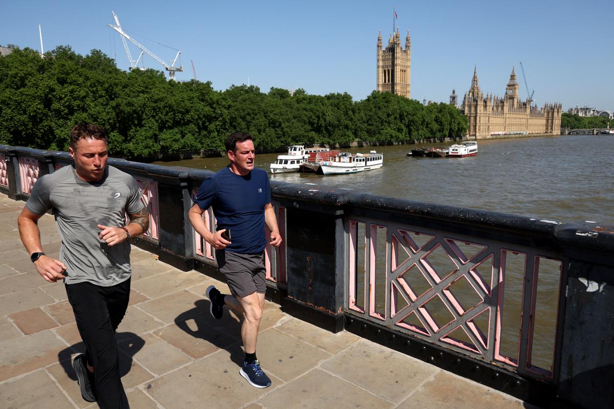  Two men run across Lambeth Bridge in London, England on May 26, 2026. 