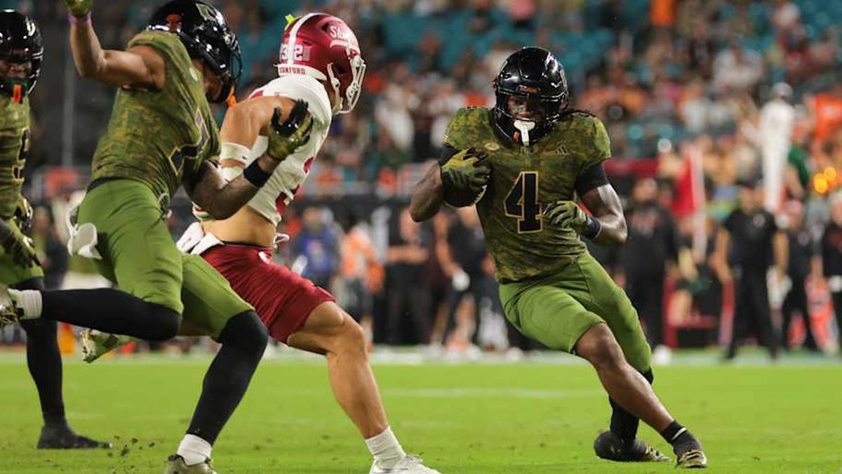  Oct 25, 2025; Miami Gardens, Florida, USA; Miami Hurricanes running back Mark Fletcher Jr. (4) carries the football against Stanford Cardinal safety Mitch Leigber (32) during the third quarter at Hard Rock Stadium. Mandatory Credit: Sam Navarro-Imagn Images | Sam Navarro-Imagn Images 