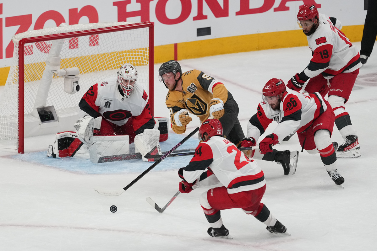 Jun 14, 2026; Las Vegas, Nevada, USA; Vegas Golden Knights center Jack Eichel (9) reaches for the puck in front of Carolina Hurricanes goaltender Brandon Bussi (32) during the third period in game six of the 2026 Stanley Cup Final at T-Mobile Arena. Mandatory Credit: Lucas Peltier-Imagn Images