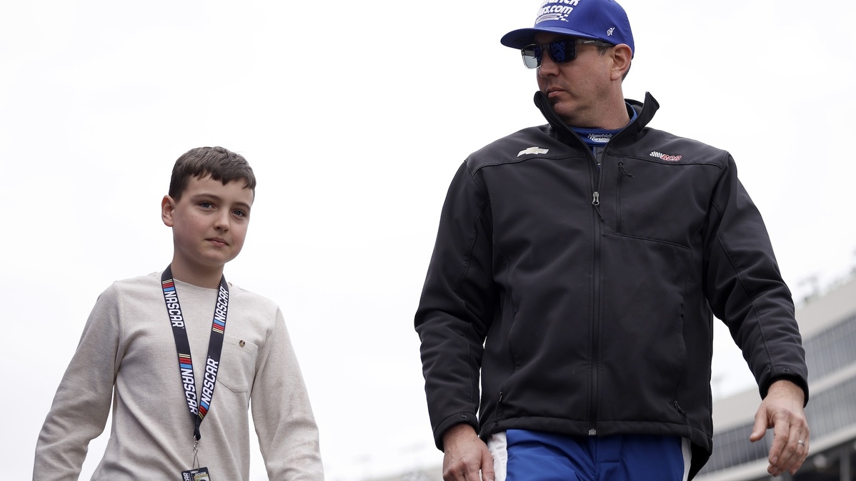 HAMPTON, GEORGIA - FEBRUARY 21: Kyle Busch, driver of the #7 HendrickCars.com Chevrolet, and son, Brexton Busch walk onstage during driver intros prior to the NASCAR Craftsman Truck Series Fr8 Racing 208 at Echo Park Speedway on February 21, 2026 in Hampton, Georgia. (Photo by Sean Gardner/Getty Images)