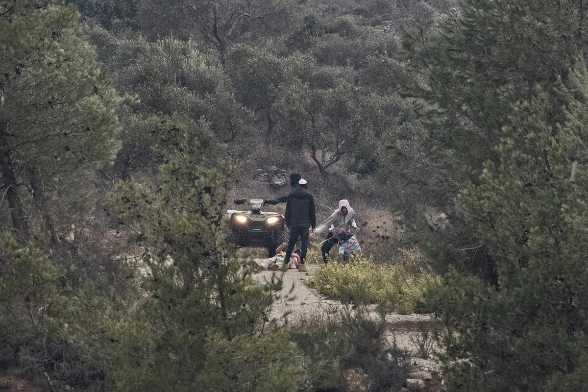 FILE -- Israeli settlers attack two men who were harvesting their olive trees in Huwara in the West Bank, Oct. 9, 2025. The Israeli government has spent heavily to provide security equipment, like off-road vehicles, to settlers. (Daniel Berehulak/The New York Times)
