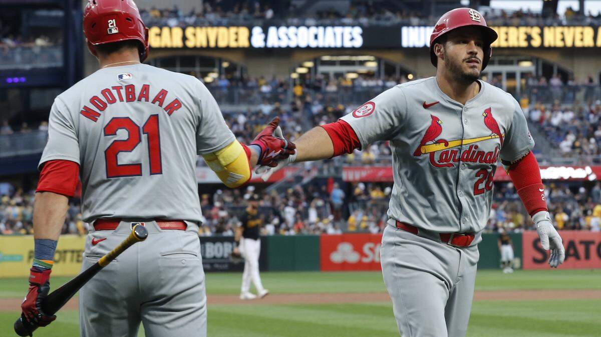 Jul 23, 2024; Pittsburgh, Pennsylvania, USA; St. Louis Cardinals right fielder Lars Nootbaar (21) congratulates third baseman Nolan Arenado (28) crossing home plate on a solo home run against the Pittsburgh Pirates during the fifth inning at PNC Park.