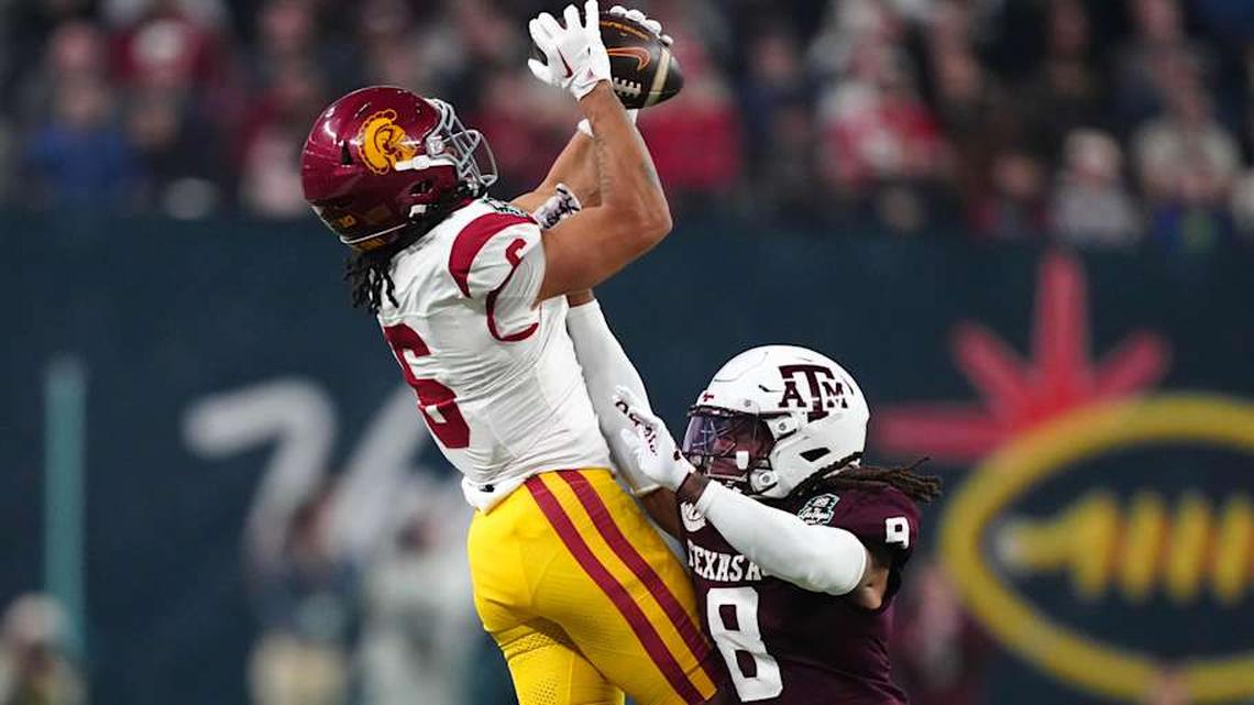  Dec 27, 2024; Las Vegas, NV, USA; Southern California Trojans wide receiver Makai Lemon (6) catches the ball against Texas A&M Aggies defensive back Jaydon Hill (8) in the second half at Allegiant Stadium. Mandatory Credit: Kirby Lee-Imagn Images | Kirby Lee-Imagn Images 