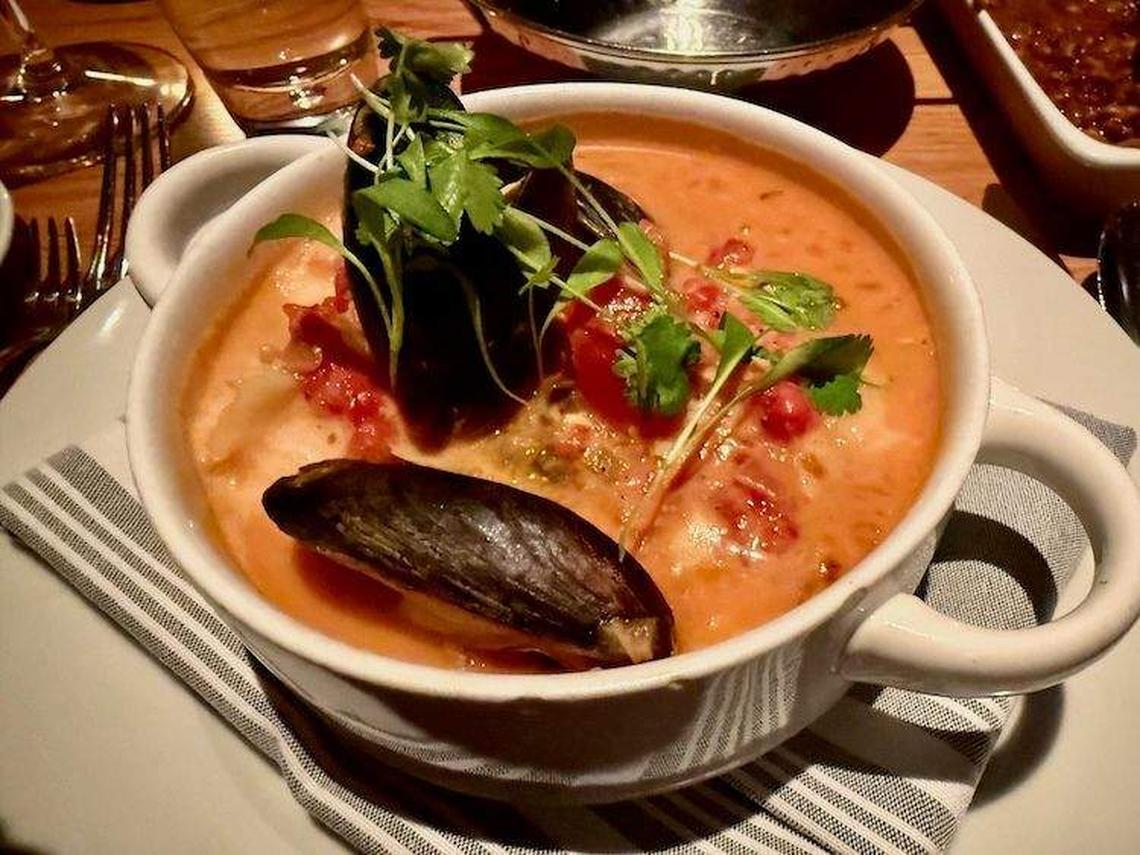  A rich coastal seafood stew at The Establishment, brimming with fish, shrimp, mussels, and scallops in a coconut-tomato broth. Photo credit: Sharon Kurtz 