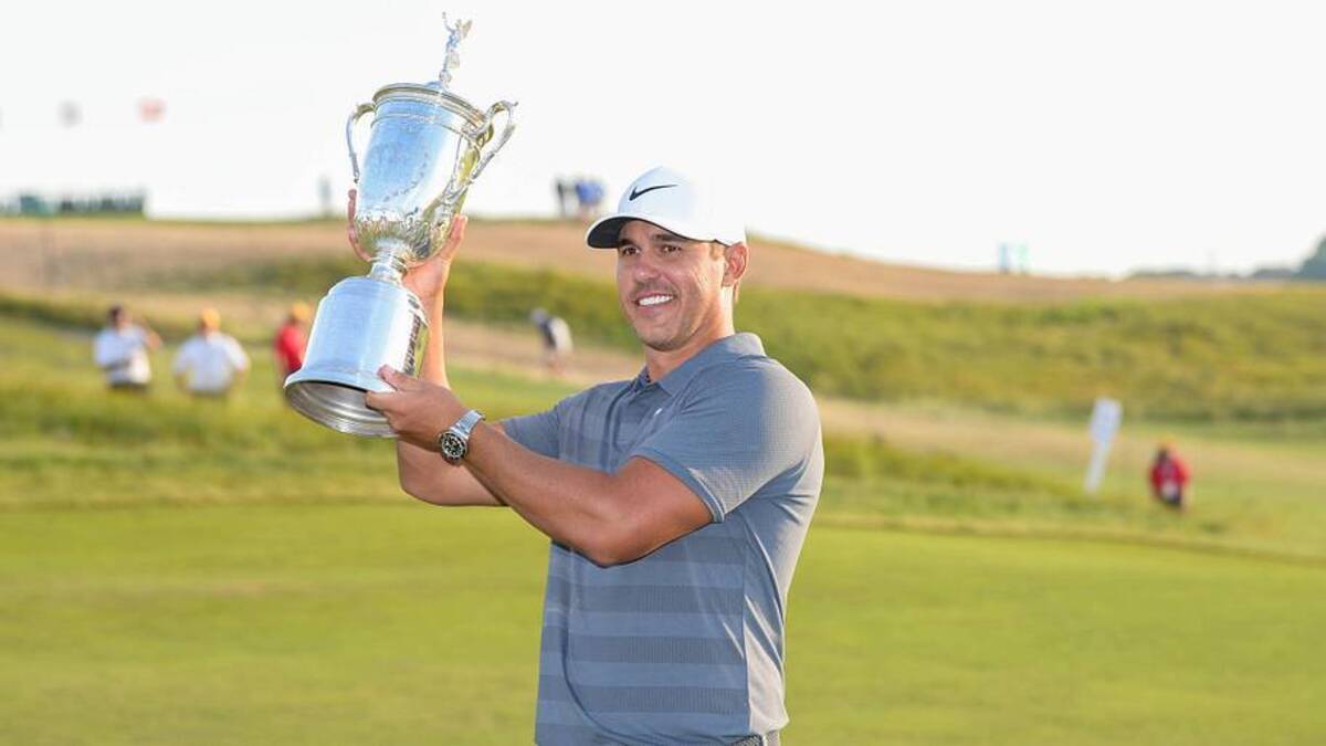  Koepka holds the trophy after winning the U.S. Open golf tournament at Shinnecock Hills Golf Club in 2018. | Dennis Schneidler-Imagn Images 