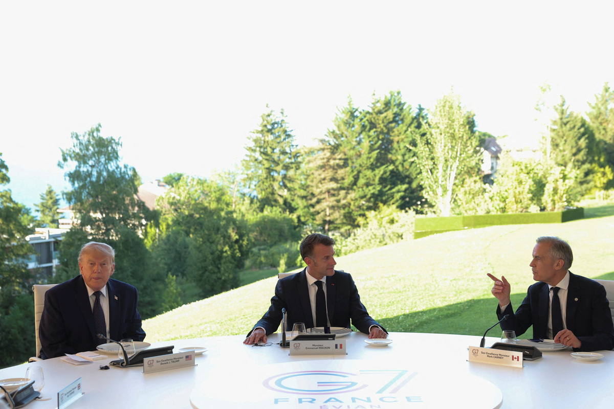 U.S. President Donald Trump, French President Emmanuel Macron and Canadian Prime Minister Mark Carney attend the G7 summit in Evian-les-Bains, France, June 15, 2026. REUTERS/Christian Hartmann
