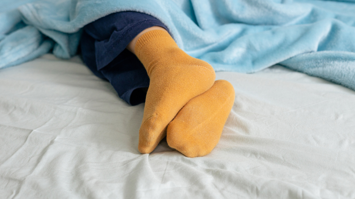 Should You Be Sleeping With Socks On? Doctors Have a Surprising Answer 
