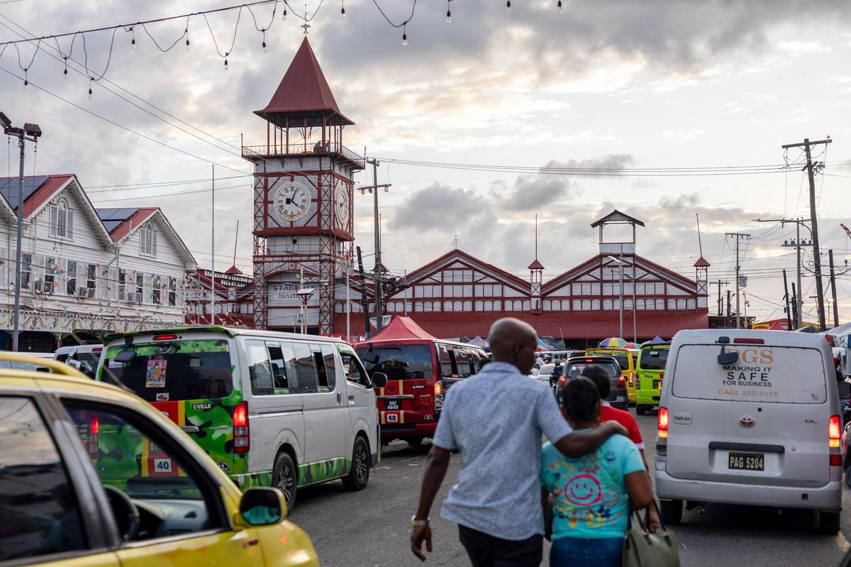 People walk outside the Stabroek Market, as Guyana's fast-growing economy is set to benefit from a reshaped global energy market due to the U.S.-Israeli war on Iran, in Georgetown, Guyana May 9, 2026. REUTERS/Yancey Haywood