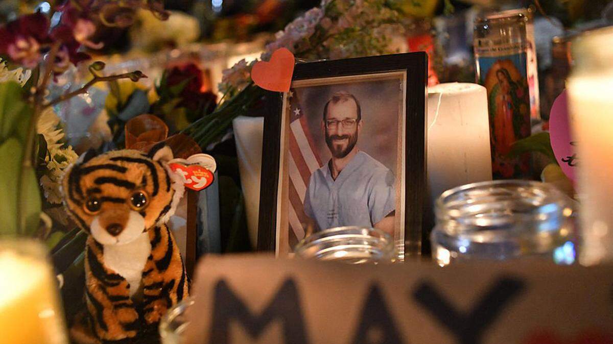 A photo of Alex Pretti is displayed on Monday at a makeshift memorial in his honor in the area where he was shot dead by federal immigration agents in Minneapolis.