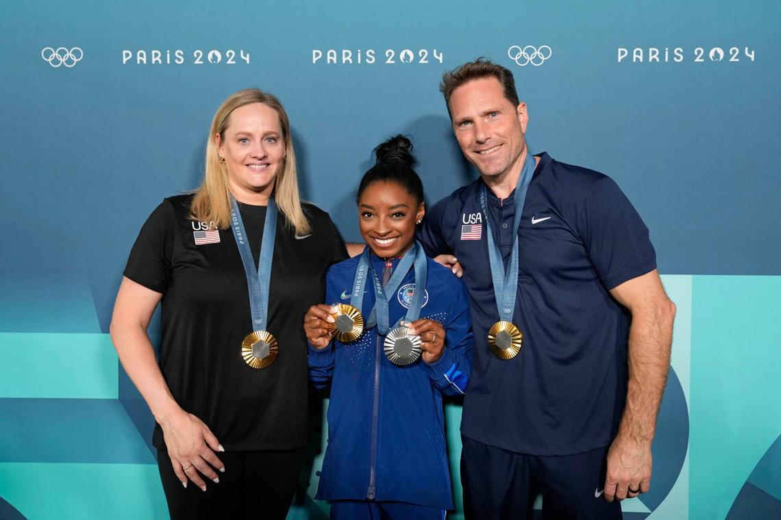  Simone Biles of the United States poses for a photo with coaches Cecile Landi and Laurent Landi after day three of the gymnastics event finals. Kyle Terada-Imagn Images