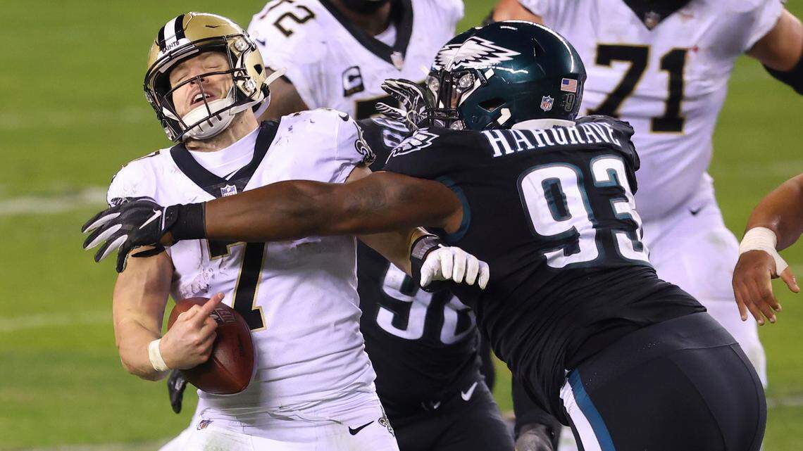 New Orleans Saints quarterback Taysom Hill (7) is sacked by Philadelphia Eagles’ Derek Barnett (96) and Javon Hargrave (93) during the fourth quarter of an NFL football game, Sunday, Dec. 13, 2020, in Philadelphia. The Eagles defeated the Saints 24-21.