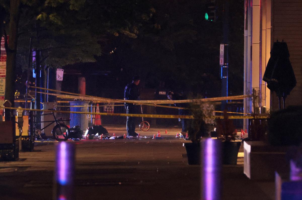 Law enforcement agents examine the evidence inside a cordoned off area on the street after a shooting incident near the White House in Washington, D.C., U.S., May 23, 2026. REUTERS/Kylie Cooper