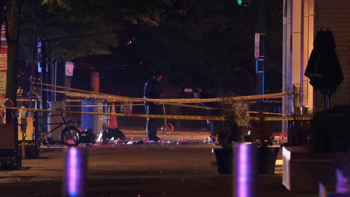 Law enforcement agents examine the evidence inside a cordoned off area on the street after a shooting incident near the White House in Washington, D.C., U.S., May 23, 2026. REUTERS/Kylie Cooper