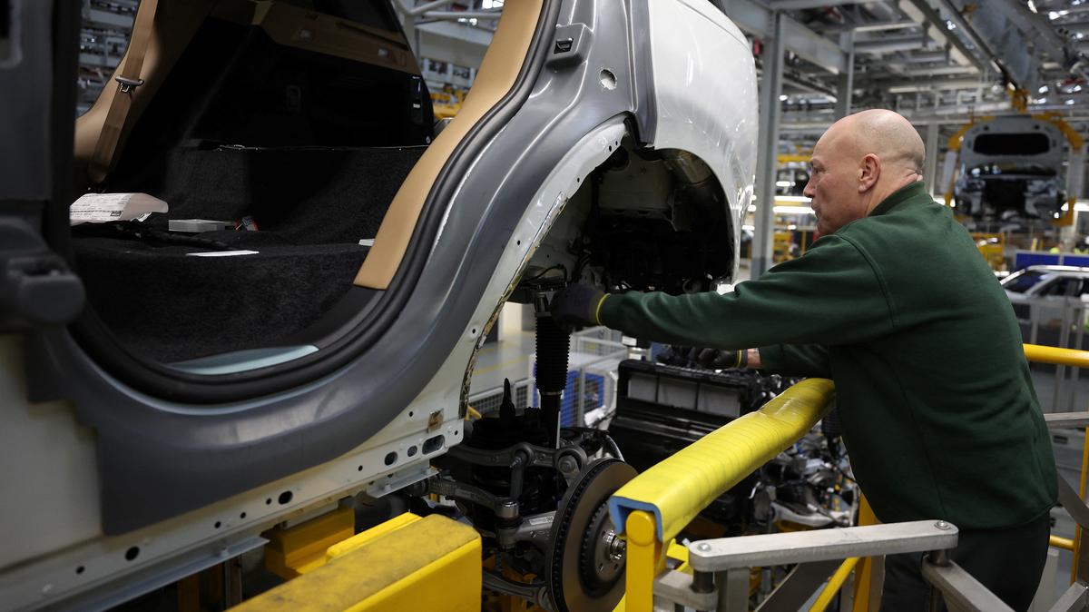 A member of staff works on the production line at Jaguar Land Rover’s factory in Solihull, Britain, December 15, 2022. REUTERS/Phil Noble