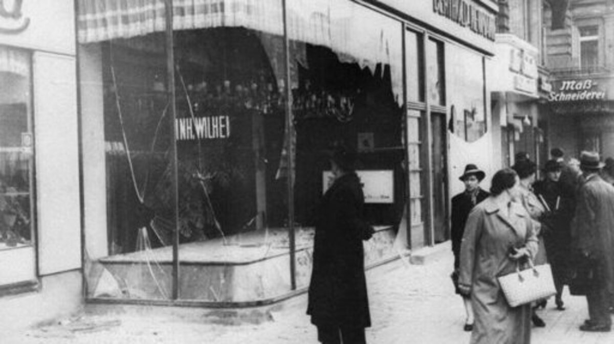 A man looks at the wreckage of a Jewish shop in Berlin on Nov. 10, 1938, in the aftermath of Kristallnacht, an organized nationwide attack carried out by Nazi paramilitary forces and German civilians over two days. The rampage, during which the perpetrators set fire to hundreds of synagogues, looted thousands of Jewish businesses and attacked Jews throughout Germany, is often considered the beginning of the Holocaust.