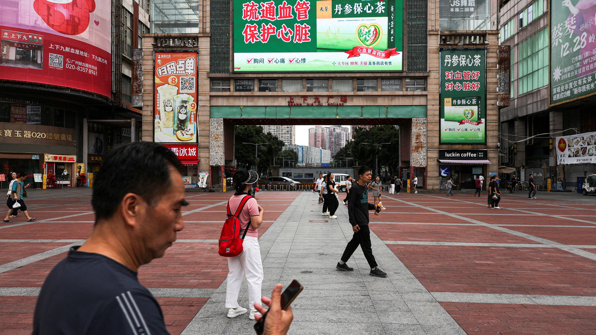 FILE PHOTO: People walk in a square in Guangzhou, Guangdong province, China, April 15, 2026. REUTERS/Go Nakamura/File Photo