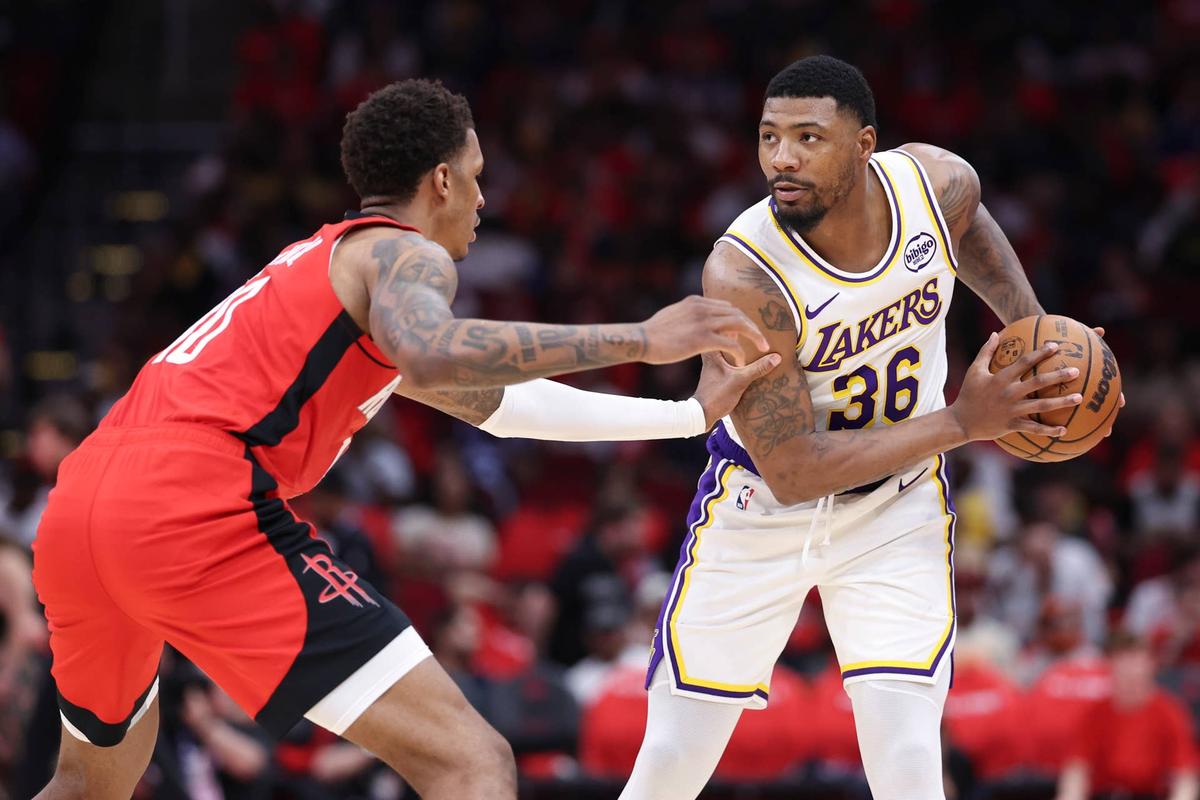  Los Angeles Lakers guard Marcus Smart controls the ball as Houston Rockets forward Jabari Smith Jr. defends during their playoff game at Toyota Center on April 26, 2026. Troy Taormina-Imagn Images