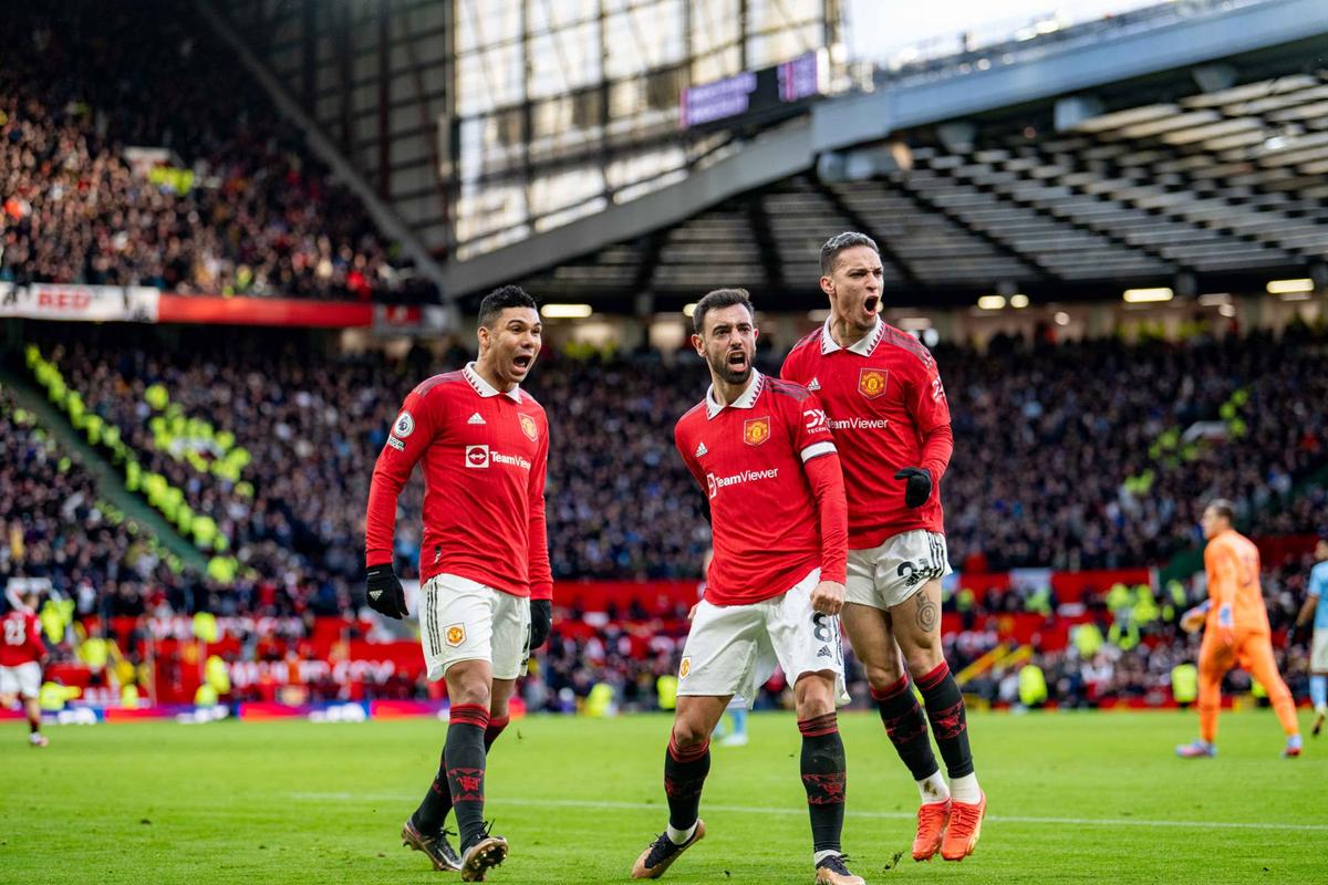  Bruno Fernandes celebrates scoring a goal with his team-mates Casemiro and Antony during the Premier League match between Manchester United and Manchester City. Ash Donelon via Getty Images