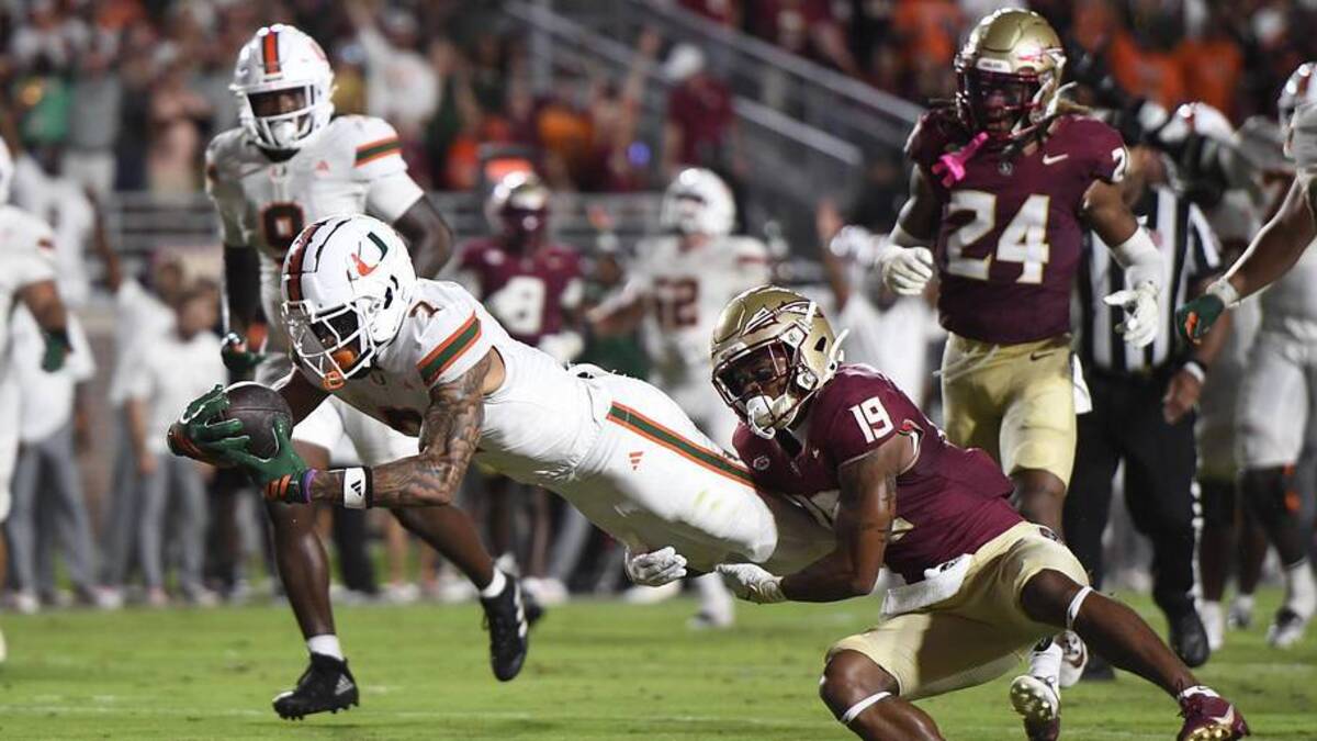  Oct 4, 2025; Tallahassee, Florida, USA; Miami Hurricanes wide receiver CJ Daniels (7) scores a touchdown against Florida State Seminoles defensive back Jerry Wilson (19) during the second half at Doak S. Campbell Stadium. Mandatory Credit: Robert Myers-Imagn Images | Robert Myers-Imagn Images 