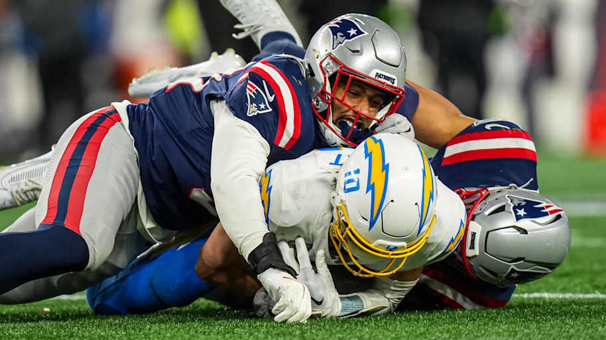 Jan 11, 2026; Foxborough, MA, USA; New England Patriots linebacker Elijah Ponder (91) and linebacker Christian Elliss (53) take down Los Angeles Chargers quarterback Justin Herbert (10) during the second half in an AFC Wild Card Round game at Gillette Stadium. Mandatory Credit: David Butler II-Imagn Images | David Butler II-Imagn Images 