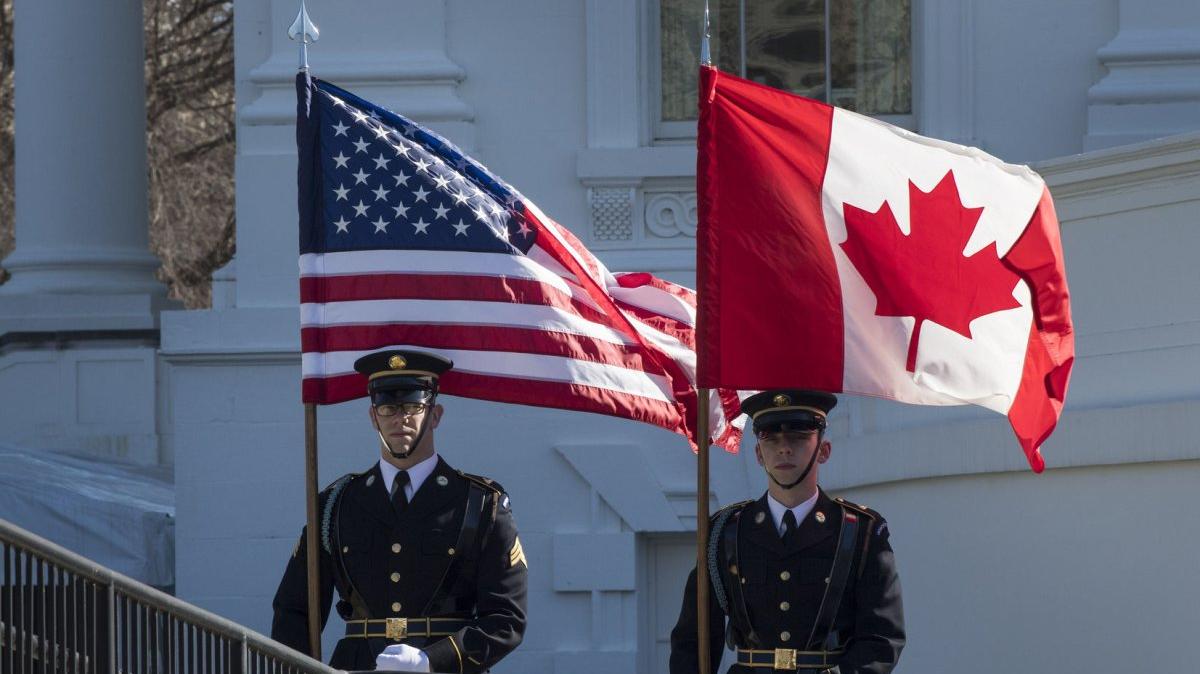 Members of a Military Honor Guard stand with an American flag and a Canadian flag at the White House in Washington, D.C., on February 13, 2017. On Monday, the Defense Department said it was suspending its involvement in a joint military board with Canada. File Photo by Pat Benic/UPI