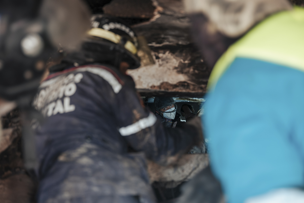 Firefighters searching for survivors dig through a crawlspace in a building that collapsed in last week's earthquakes in La Guaira, Venezuela, on Monday, June 29, 2026. It has been six days since devastating twin earthquakes flattened entire residential neighborhoods in Venezuela, and dozens of new bodies are still being hauled out of the rubble. (Adriana Loureiro Fernandez/The New York Times)