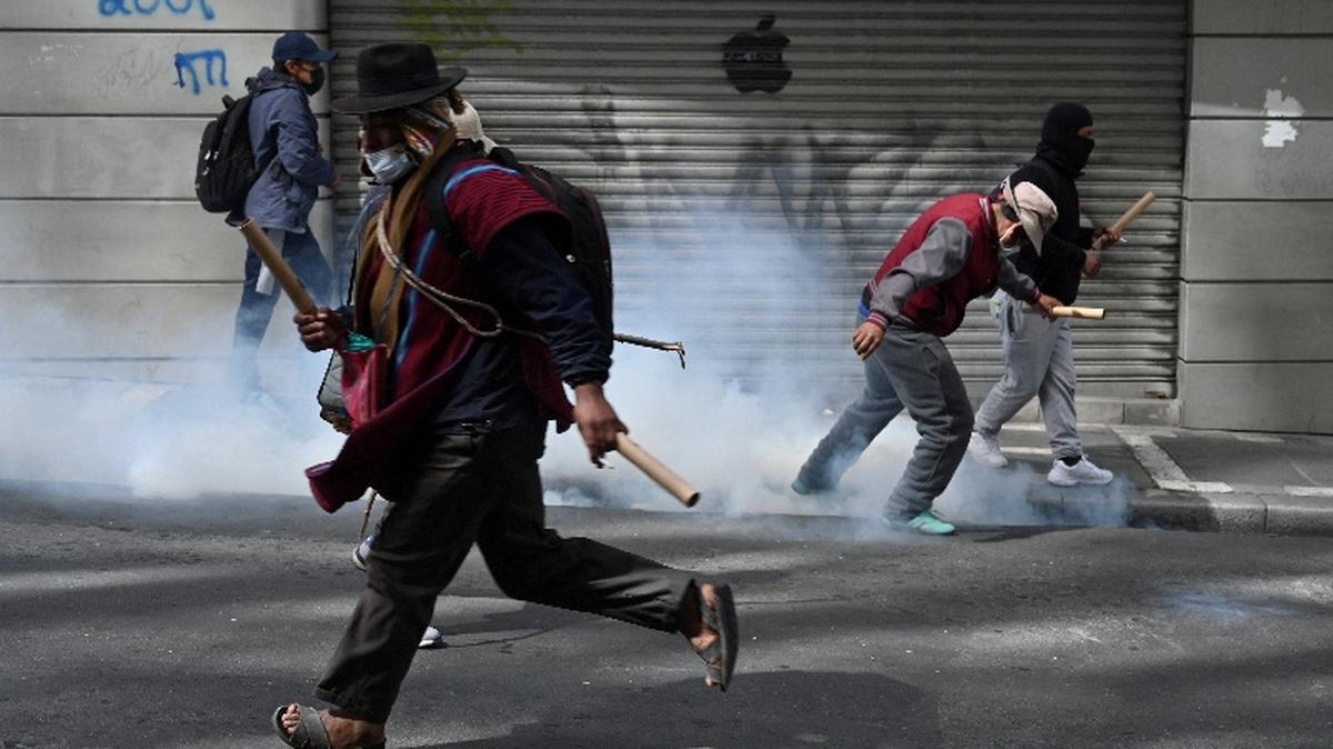 A demonstrator runs as protesters clash with law enforcement during a march calling for the resignation of Bolivia's President Rodrigo Paz, as the country's economic and fuel crisis worsens due to a shortage of U.S. dollars and falling domestic energy production, in La Paz, Bolivia. REUTERS/Claudia Morales