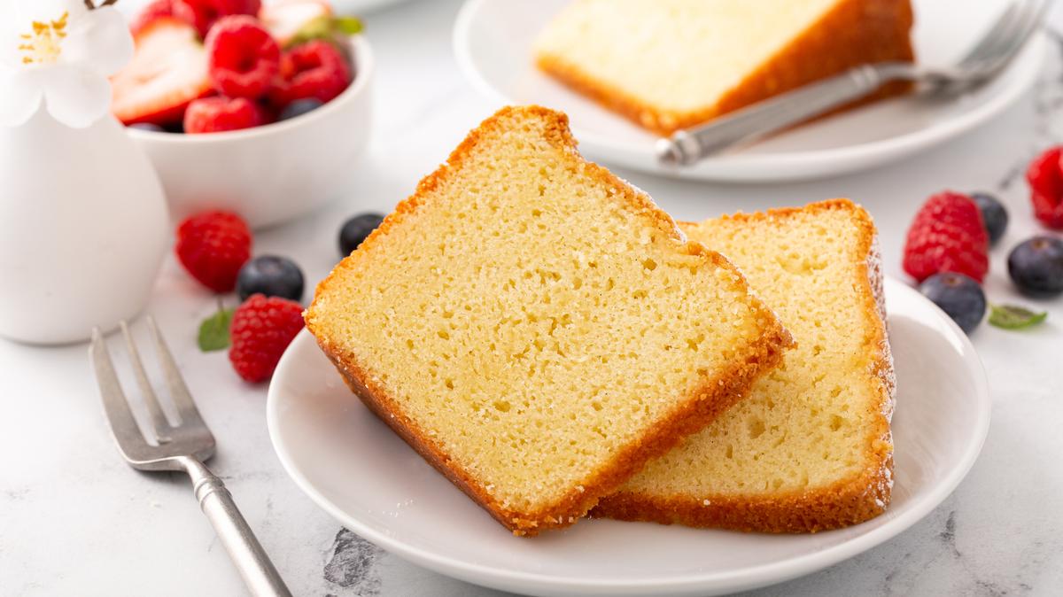 Traditional vanilla pound cake baked in a bundt pan served with fresh berries