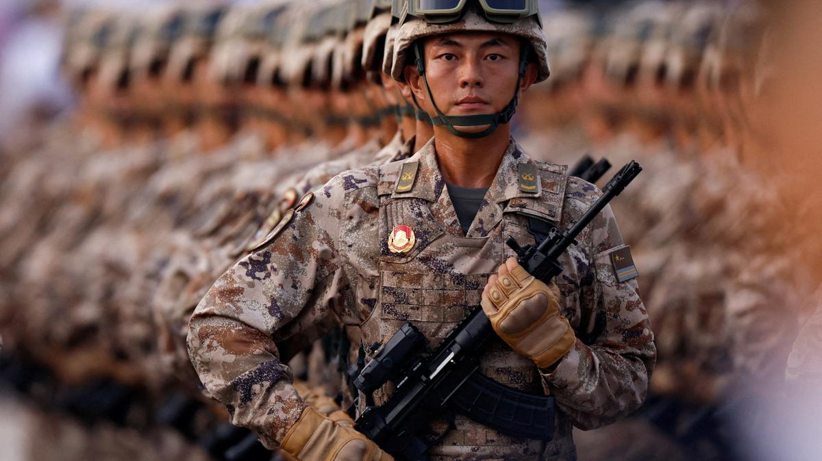China's cyber force personnel march during the rehearsal ahead of a military parade to mark the 80th anniversary of the end of World War Two, in Beijing, China, September 3, 2025. REUTERS/Tingshu Wang