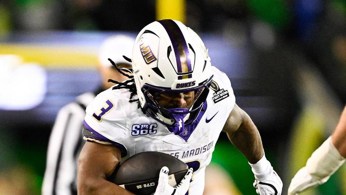  Dec 20, 2025; Eugene, OR, USA; James Madison Dukes running back Wayne Knight (3) rushes as Oregon Ducks defensive back Aaron Flowers (21) defends during the second quarter at Autzen Stadium. Mandatory Credit: Troy Wayrynen-Imagn Images | Troy Wayrynen-Imagn Images 