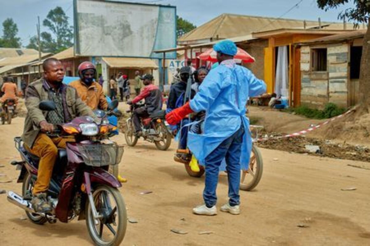 John Macki, a public health expert, controls motorcycle taxis before a health check point screening along the street, as aid agencies intensify efforts to contain a new Ebola outbreak involving the Bundibugyo strain outbreak, in Mongbwalu, Djugu Territory of Ituri province, which is the epicenter of the Ebola epidemic, in Democratic Republic of the Congo, May 23, 2026. REUTERS/Gradel Muyisa Mumbere