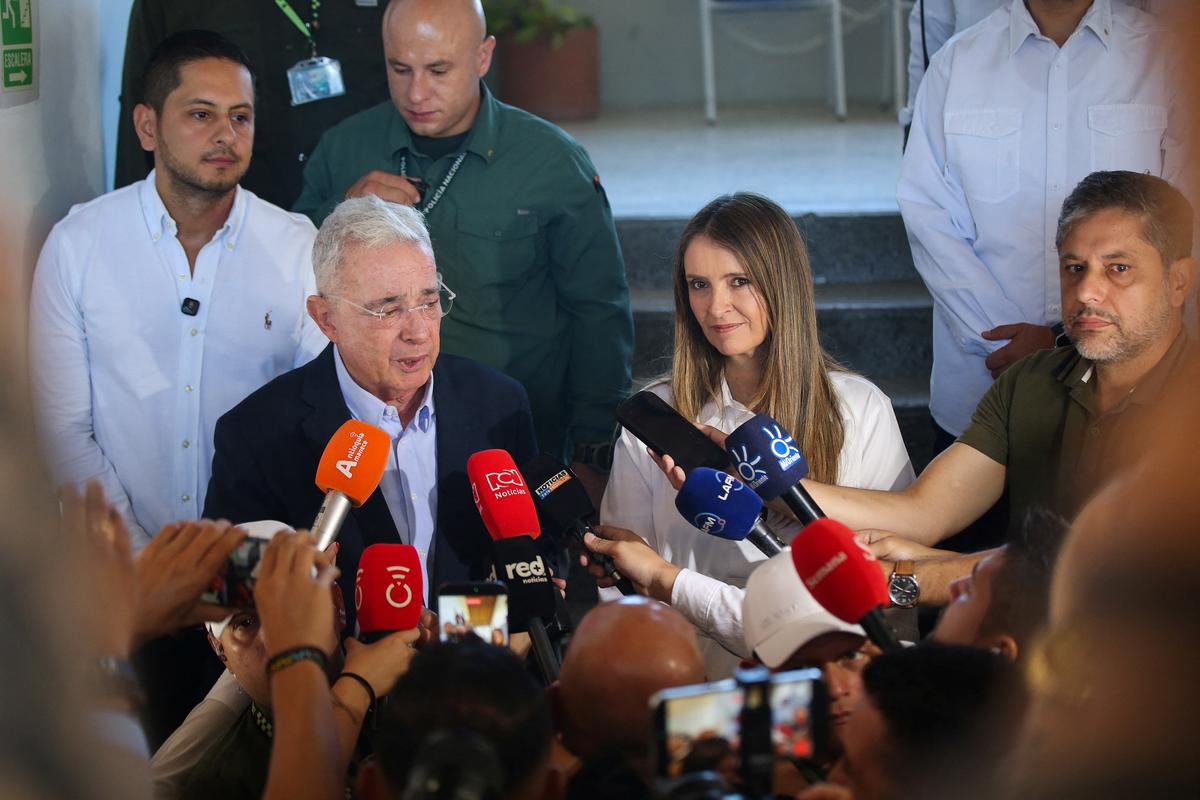 Colombia's former President Alvaro Uribe Velez accompanied by Colombian presidential candidate Paloma Valencia of the Democratic Centre party, as they speak to the press, during the first round of the presidential election, in Rio Negro, Colombia, May 31, 2026. REUTERS/Juan David Duque