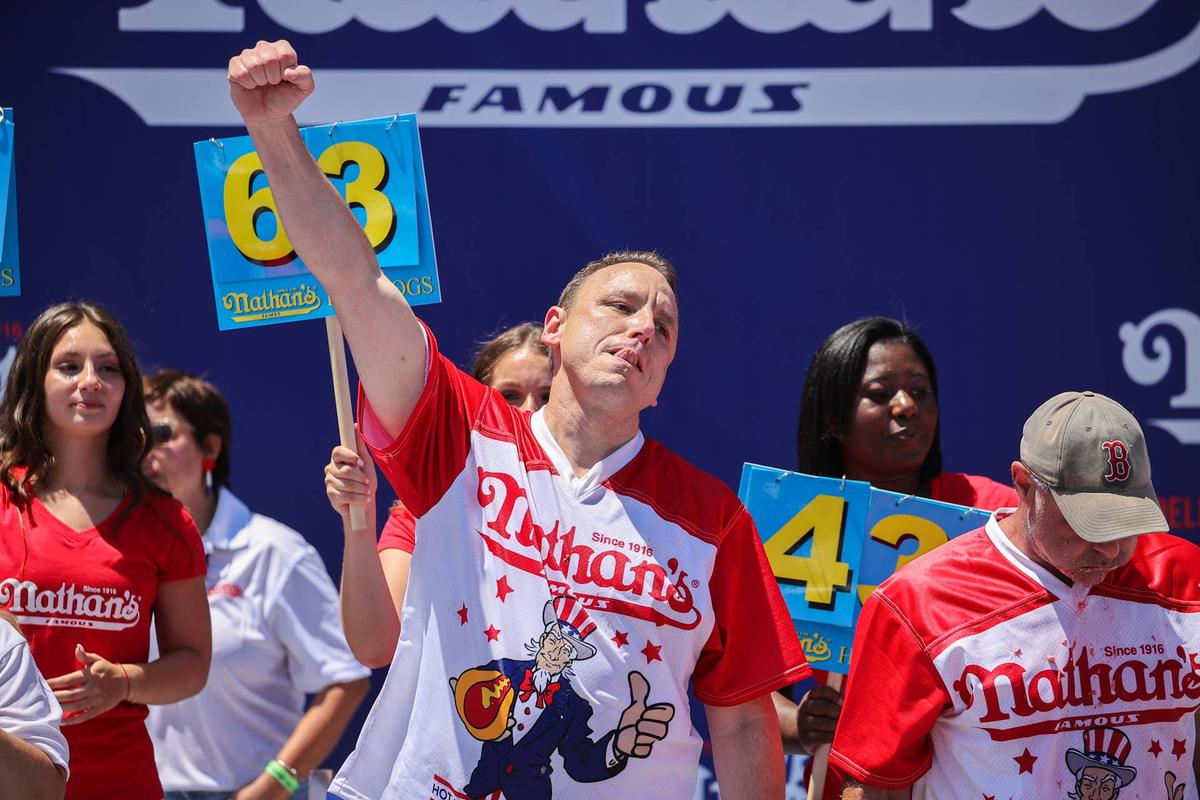  NEW YORK, USA - JULY 04: Joey Chestnut won first place eating 63 hot dogs in 10 minutes during the men 2022 Nathan's Famous International Hot Dog Eating Contest at Maimonides Park of Coney Island in the Brooklyn borough of New York City, United States on July 4, 2022. (Photo by Tayfun Coskun/Anadolu Agency via Getty Images) 