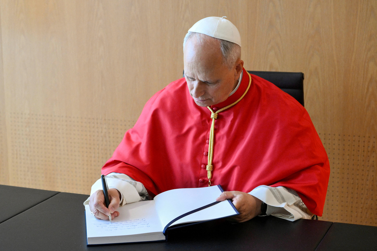 Pope Leo XIV signs a guest book during his apostolic journey, in Madrid, Spain, June 6, 2026.  Vatican Media/­Handout via REUTERS