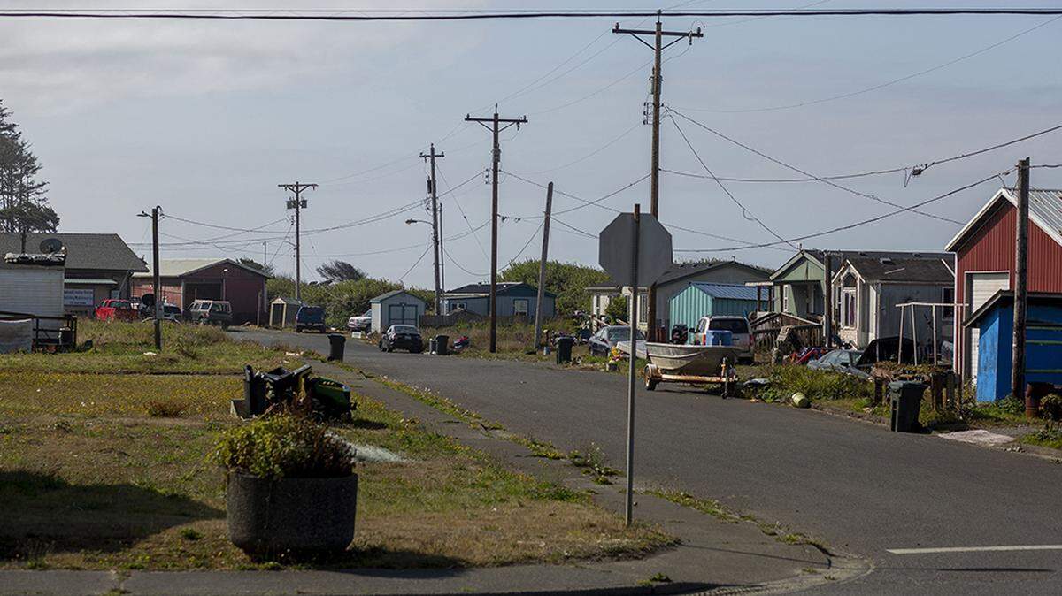 Homes in the lower village near the water are seen on the Quinault Indian Nation reservation on Aug. 9, 2021, in Taholah, Wash. Due to climate change and rising sea levels, the lower village, which has around 800 homes, is being relocated up the hill.