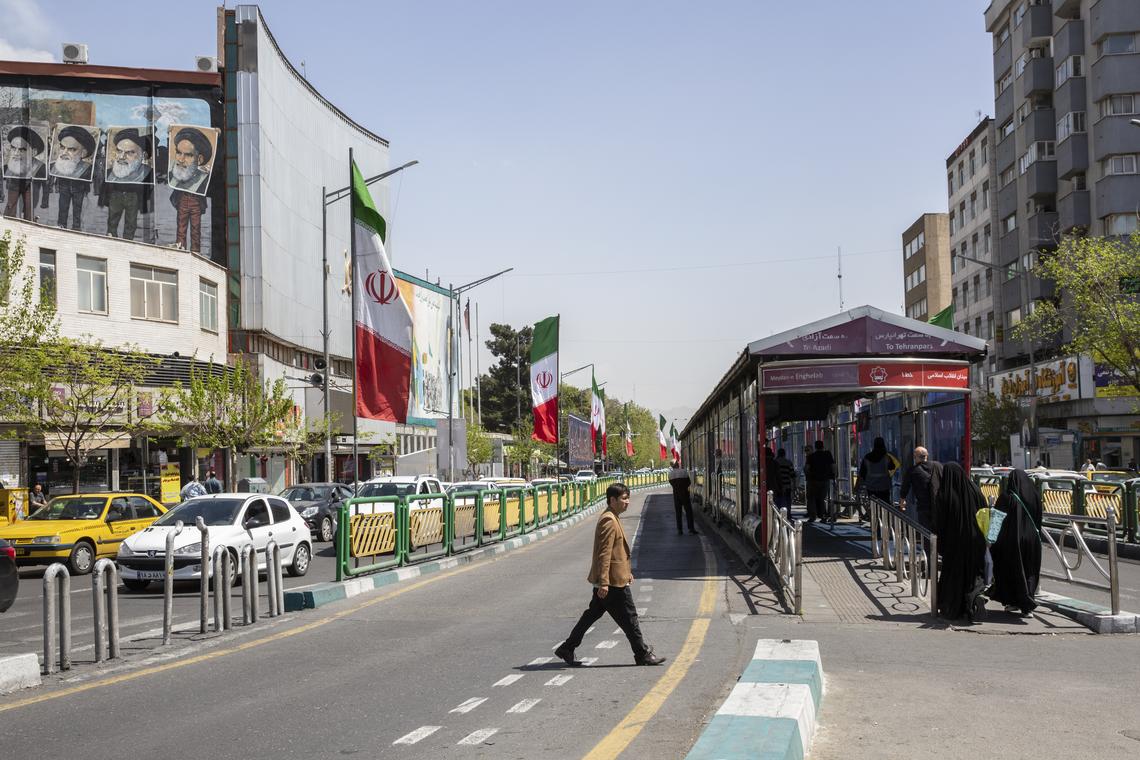 A man crosses Enghelab Street near a bus stop in Tehran, April 5, 2026. Iran on Wednesday, April 15, threatened further retaliation over an American naval blockade of its ports in the critical Strait of Hormuz as the U.S. military said that it had "completely halted" trade in and out of Iran by sea. (Arash Khamooshi/The New York Times)