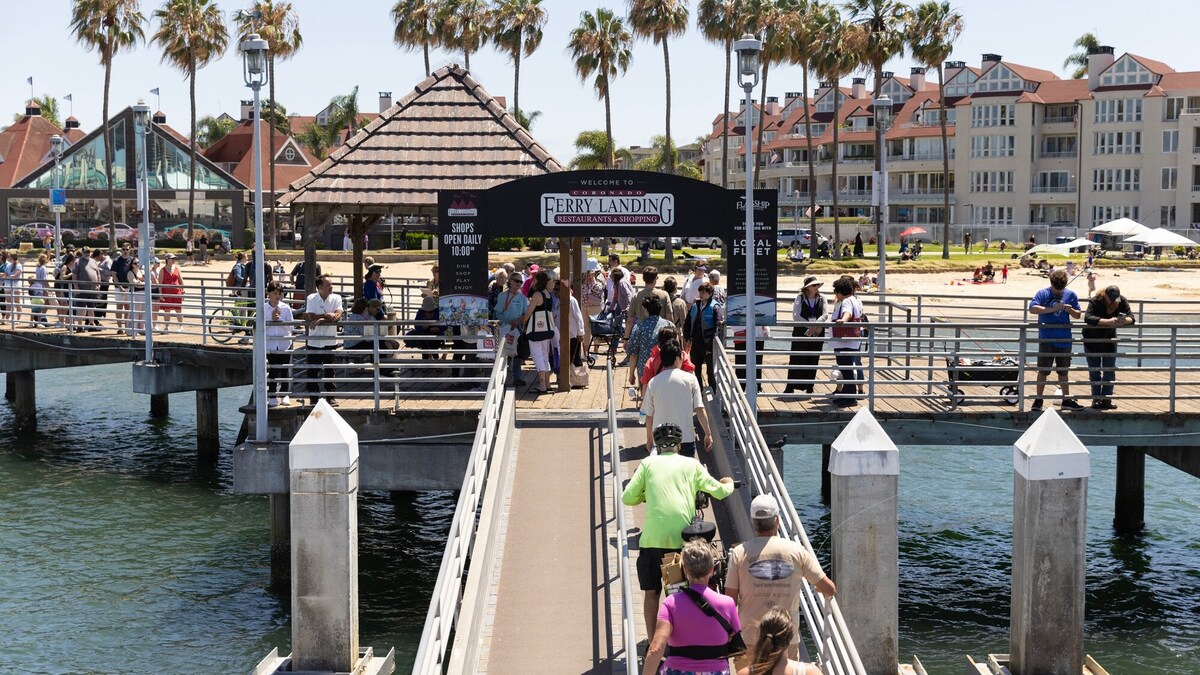 Passengers disembark a ferry from Broadway Pier at the Coronado Ferry Landing on Wednesday, June 17, 2026. The leasehold consists of single-story, retail buildings alongside a ferry and fishing pier, plaza space and two parking lots. (Luke Johnson / The San Diego Union-Tribune)